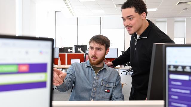 Two Male Staff Members Looking At Screen